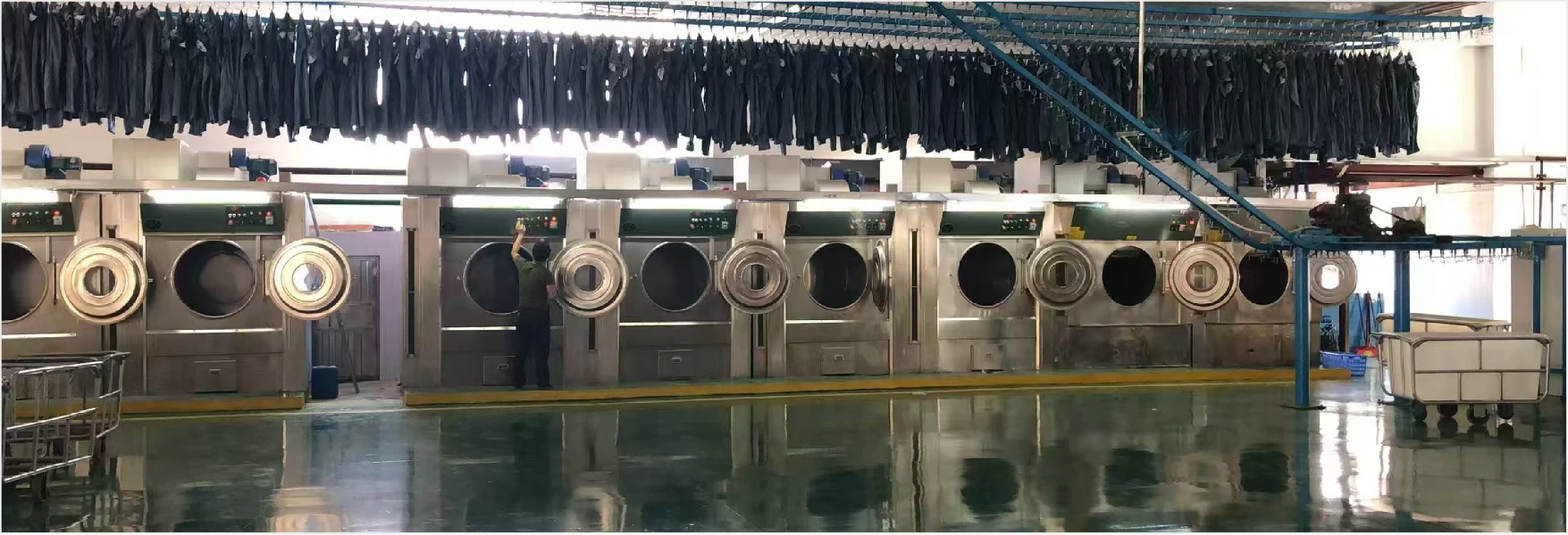 Denim garments moving through wash stage during sample run review