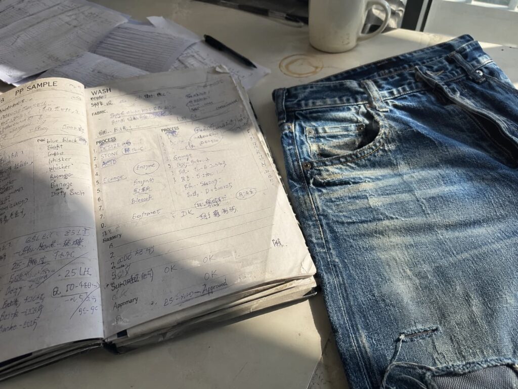 denim wash notes beside approved garment before reorder production review